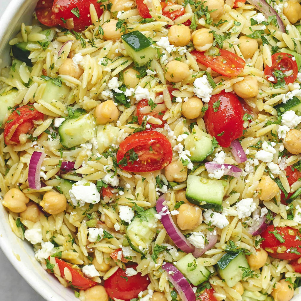 A bowl of chickpea orzo salad.