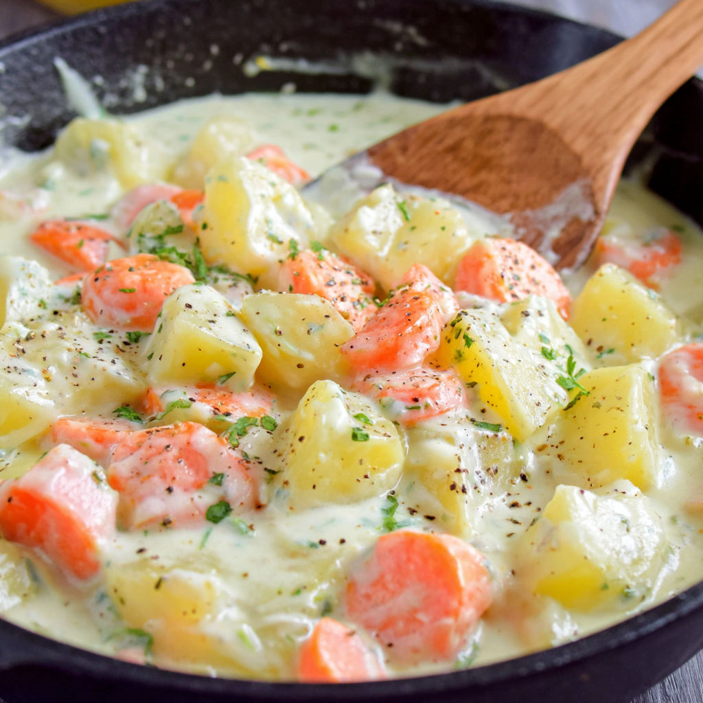 A bowl of food with a wooden spoon in it.