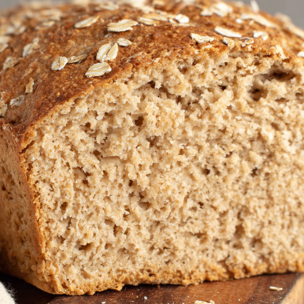 A slice of bread with seeds on top.
