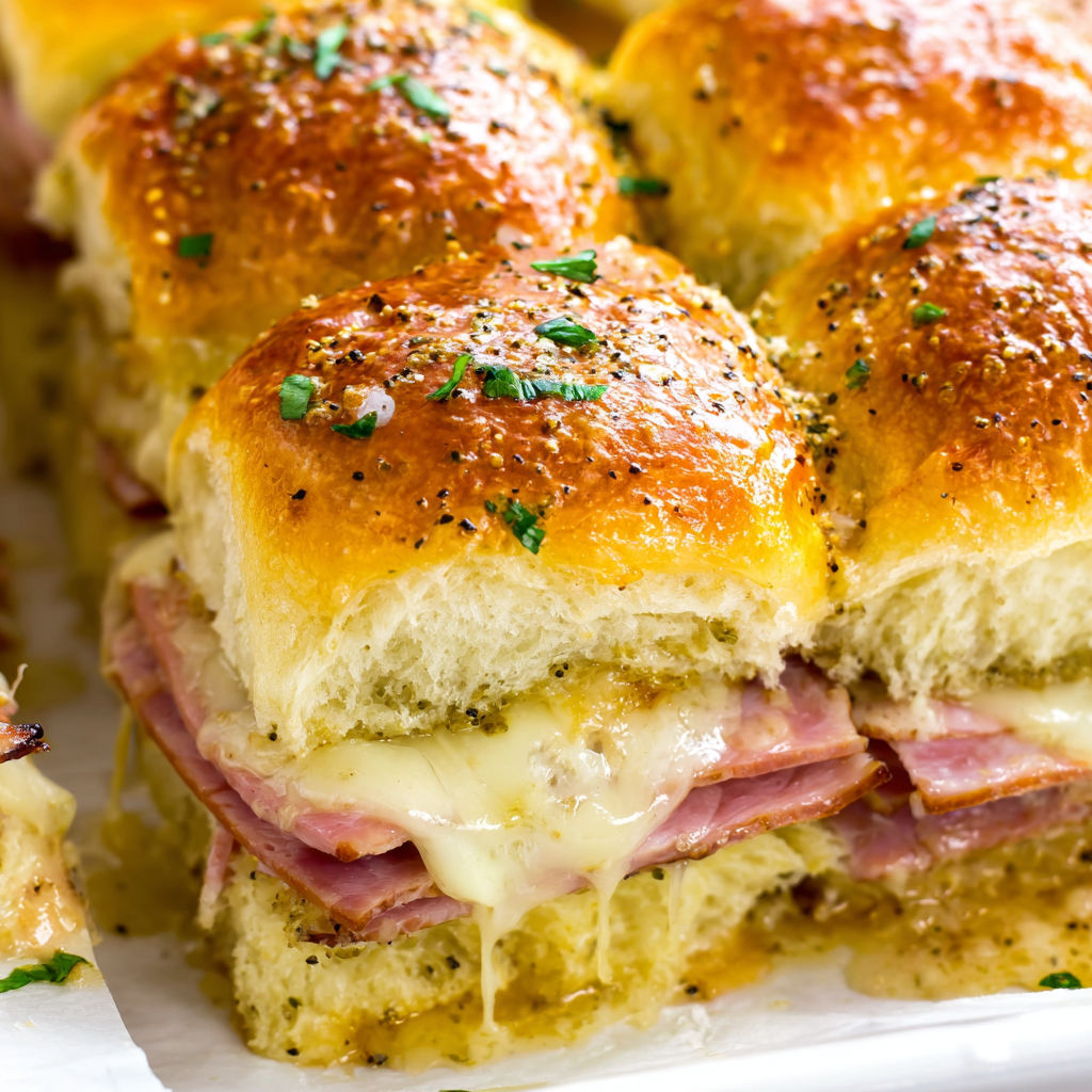 A plate of ham and cheese sliders.