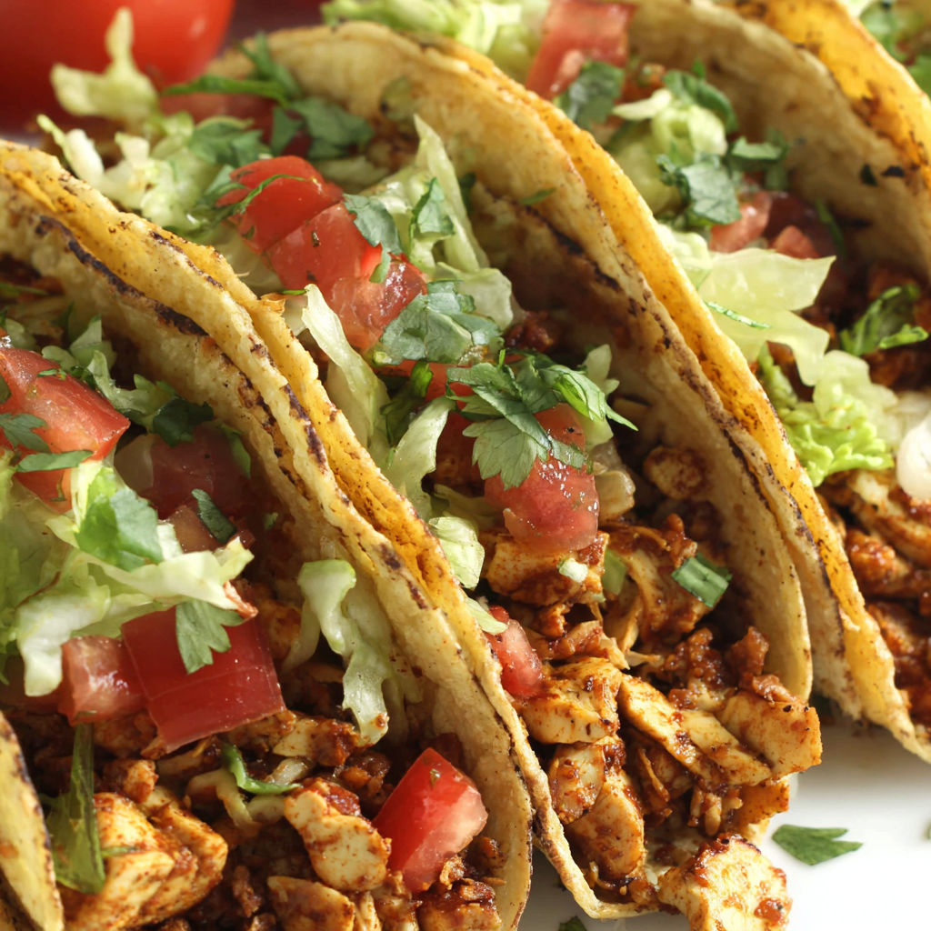 A plate of tacos with tofu meat.