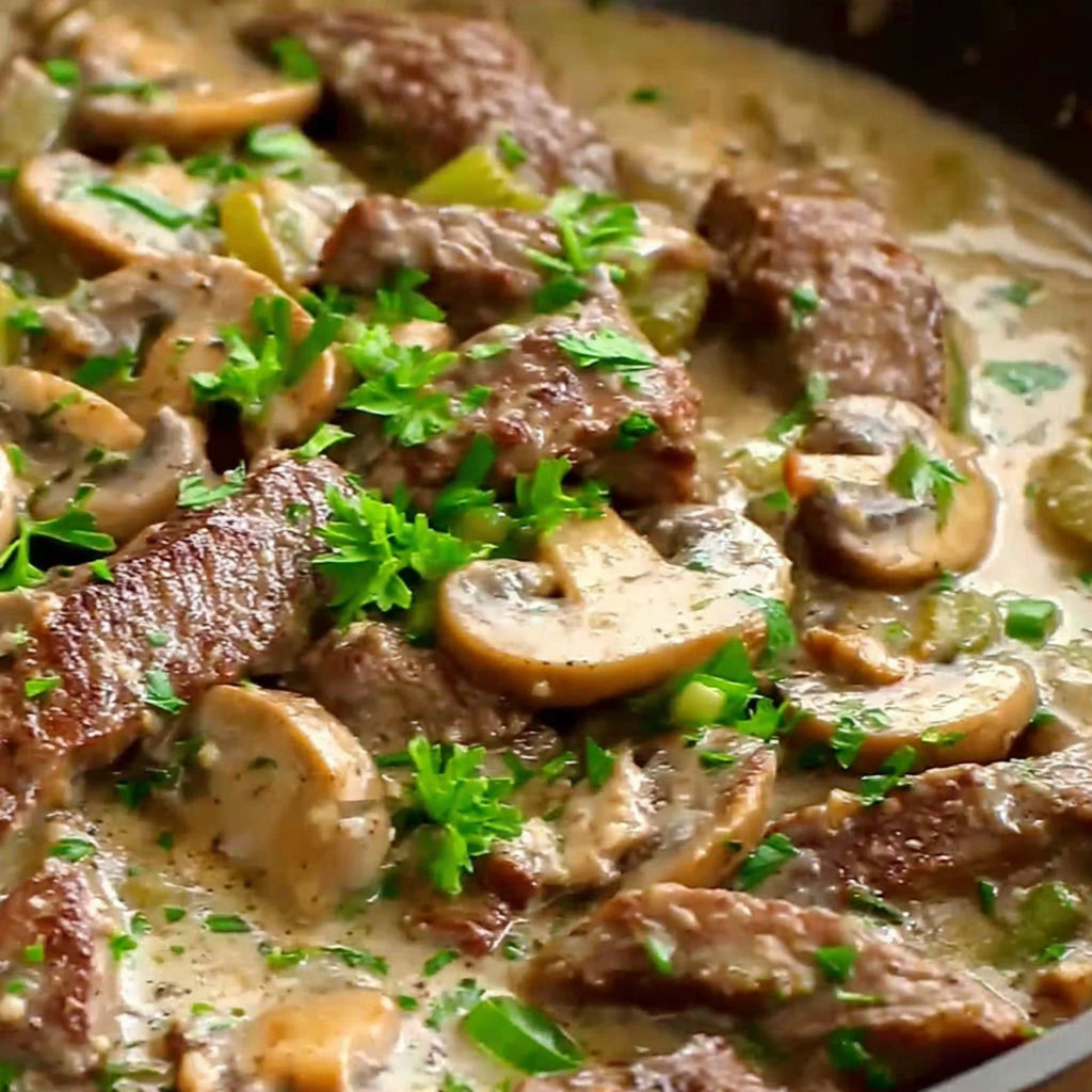 A delicious beef stroganoff with mushrooms and green onions.