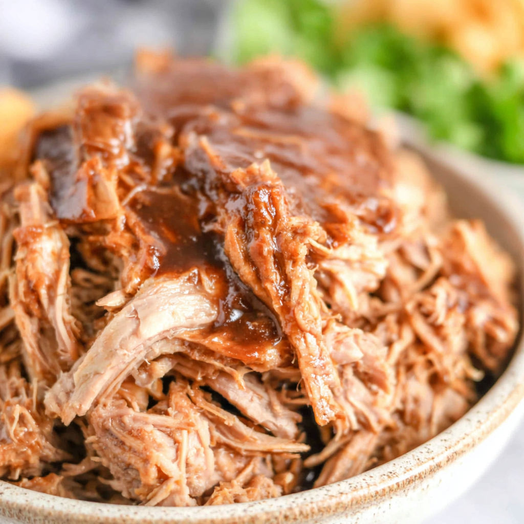 A close up of a delicious crock pot pulled pork.