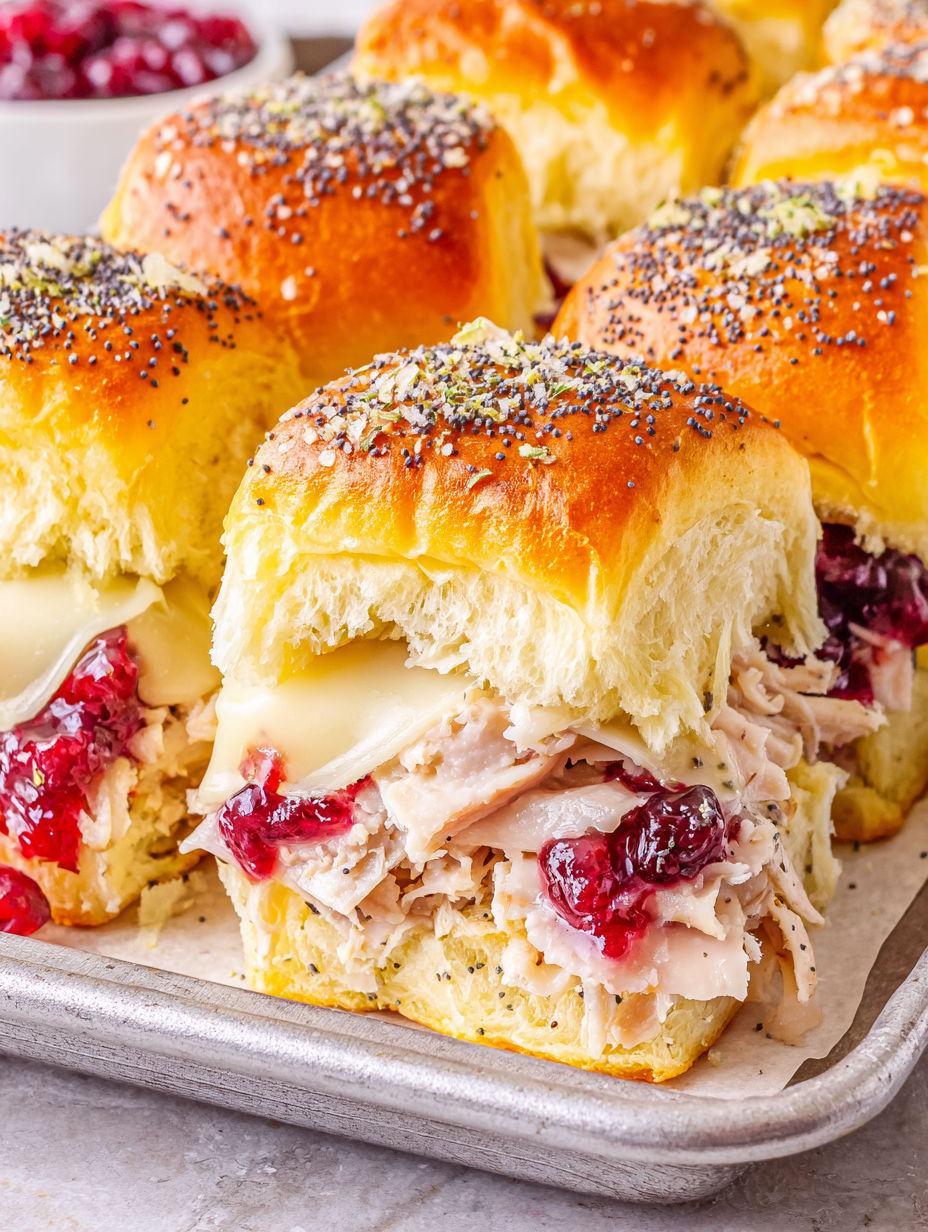 A plate of turkey and cheese sliders.