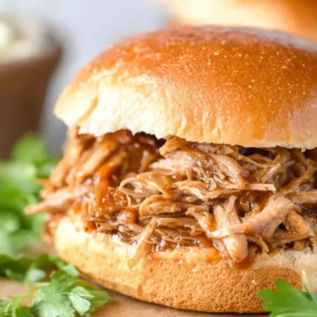 A sandwich with pulled pork in a bun.