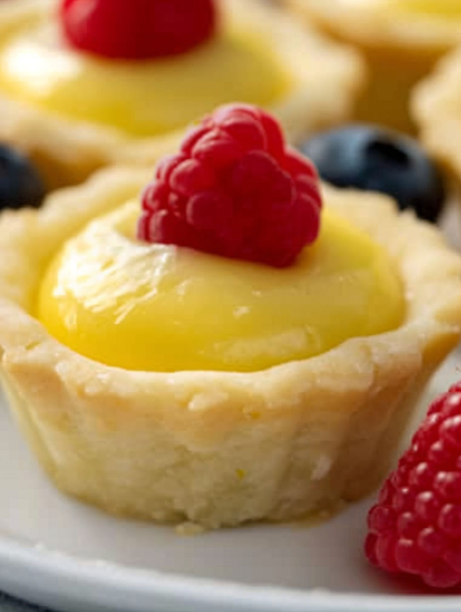 A small pastry with a raspberry on top.