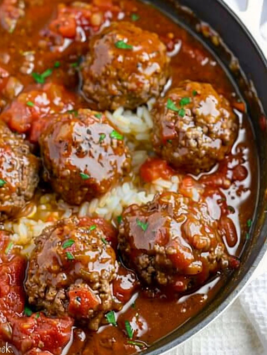 A bowl of meatballs with gravy.