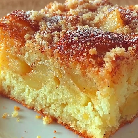 A slice of cake with powdered sugar on top.