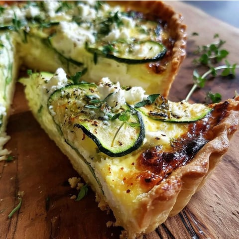 A slice of zucchini feta quiche with knoblauch and frischen kräuter.