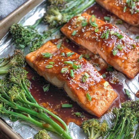 A pan of salmon with broccoli and other vegetables.