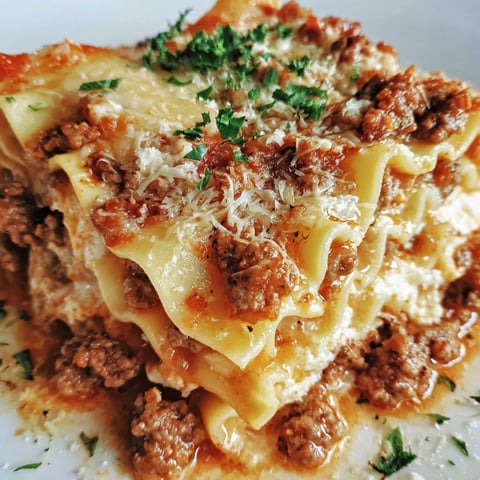 A plate of lasagna with meat and cheese.