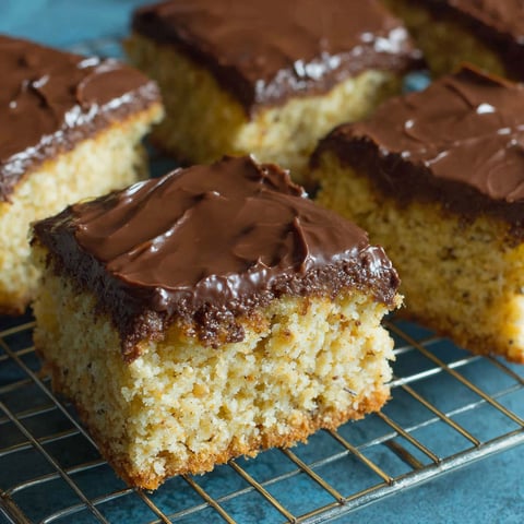 A tray of cake with chocolate frosting.