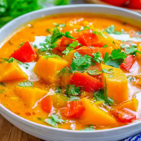 A bowl of soup with a spoon in it.