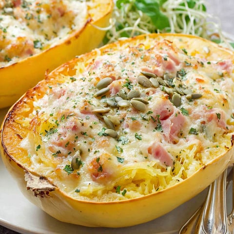 A plate of food with a spaghetti squash and cheese.