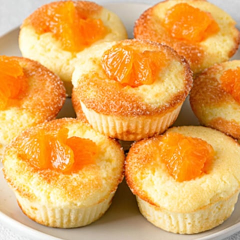 A plate of muffins with orange jelly.