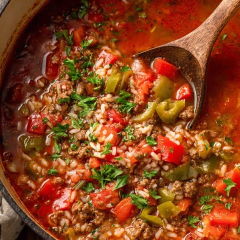 A bowl of soup with a spoon in it.