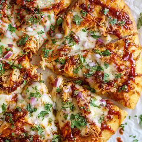 A BBQ chicken pizza with onions and green peppers.