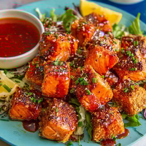 A plate of salmon bites with a honey-harissa glaze.