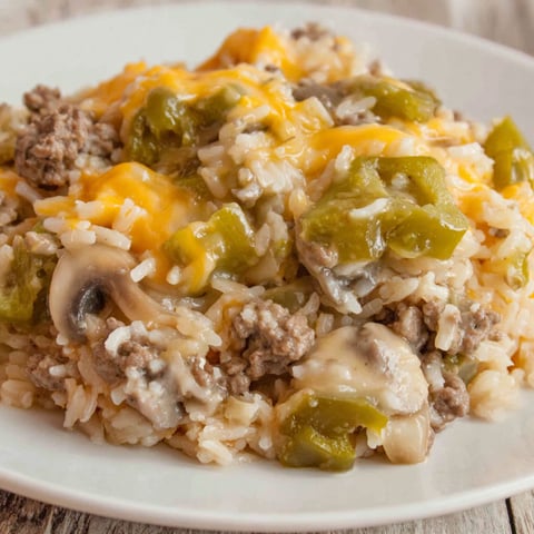 A plate of rice with ground beef and cheese.