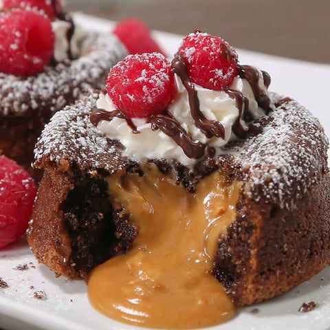 A close up of a peanut butter lava cake with chocolate drizzle.
