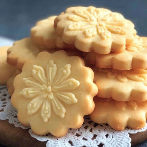 A stack of cookies with a flower design.