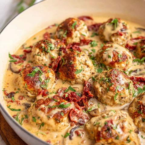 A bowl of meatballs with sauce.