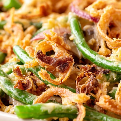 A dish of food with green beans and onions.