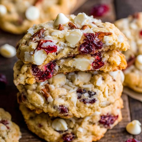White chocolate cranberry cookies stacked on a table.
