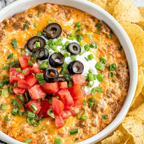 A bowl of crockpot taco dip with chips.