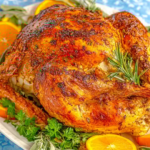 A juicy oven roasted turkey with herbs and oranges.