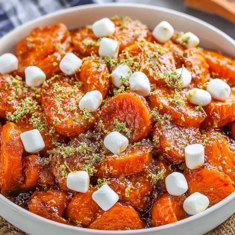 A bowl of candied yams with marshmallows on top.
