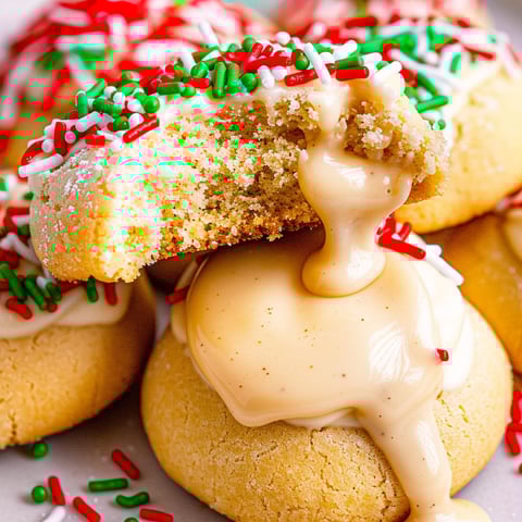 A plate of eggnog teacakes with white icing.