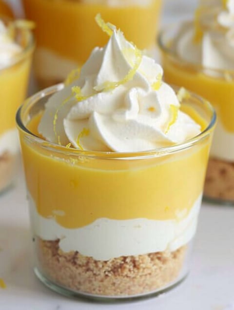 A glass of lemon parfait with whipped cream.