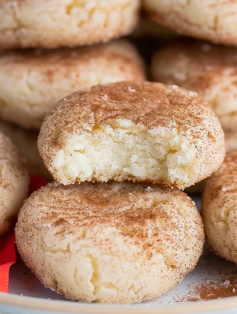 A close up of a cookie with cinnamon and cream cheese.