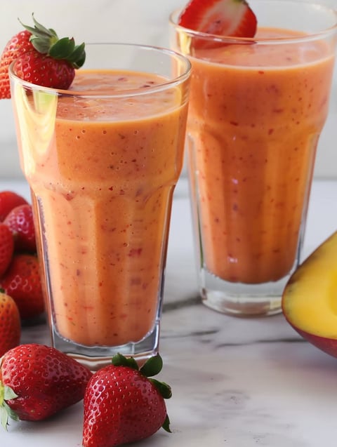 Two glasses of strawberry mango smoothie.