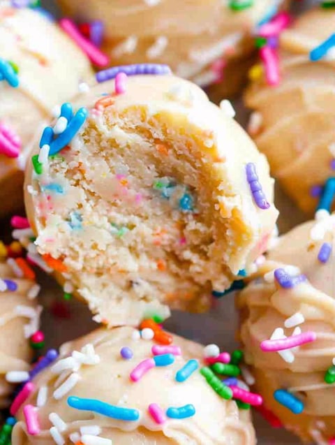 A close up of a cake with sprinkles.