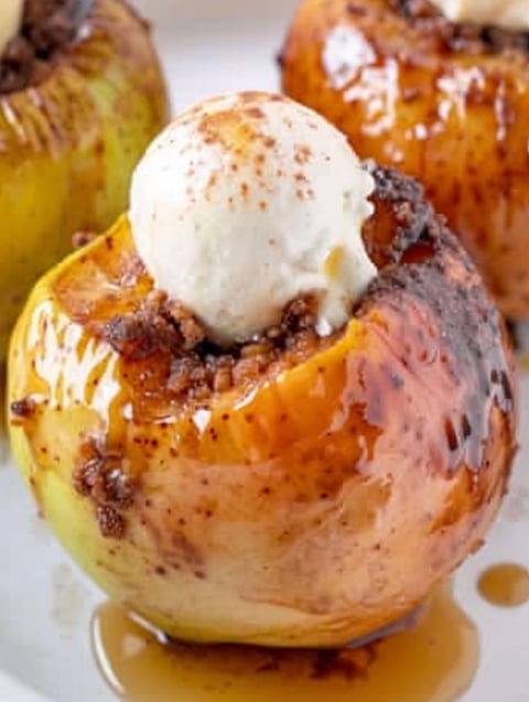 A peeled apple with a scoop of ice cream on top.