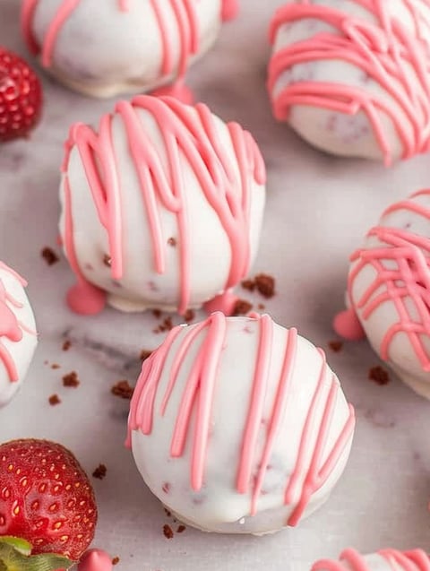 Pink and white Oreo balls with strawberries.