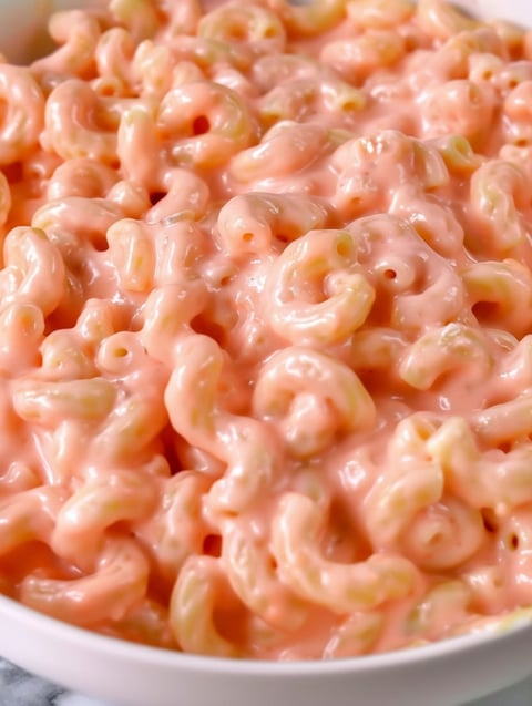 A bowl of pink mac and cheese.