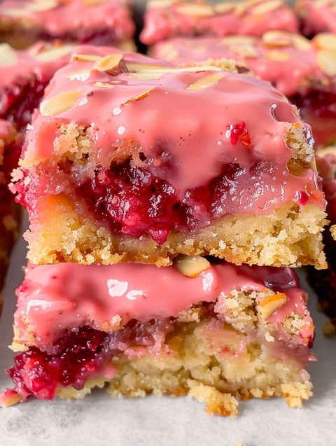 A close up of a white chocolate raspberry blondie.
